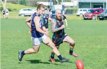  ??  ?? Kilcunda Bass player Dylan Stacey races Cora Lynn opponent Travis Ramsdale for the ball in the Reserves match; Photograph­s: Craig Johnson.