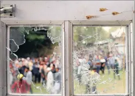  ?? WASEEM ANDRABI/ HT ?? Villagers near a mosque which was damaged during a gunfight between militants and security forces at Panzan village in central Kashmir’s Budgam district on Thursday.