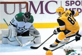  ?? AP PHOTO ?? Sidney Crosby of the Pittsburgh Penguins collects a rebound off Dallas Stars goaltender Anton Khudobin before scoring a first-period goal during Wednesday’s game in Pittsburgh.