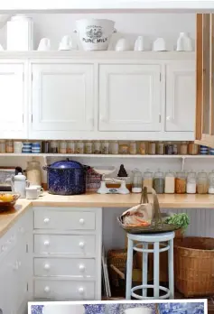  ??  ?? MADE TO MEASURE The units were made by Steve Coe. The worktops are maple. The couple bought the enamel bread bin in California in the 1970s. The trug on the Thonet Bentwood stool is from The Hambledon Gallery.