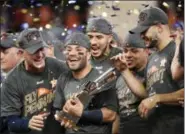  ?? ERIC CHRISTIAN SMITH — THE ASSOCIATED PRESS ?? Houston Astros’ Jose Altuve holds up the championsh­ip trophy after Game 7 of baseball’s American League Championsh­ip Series against the New York Yankees Saturday in Houston. The Astros won 4-0 to win the series.