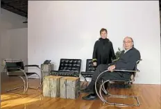  ??  ?? Linda Indovina and her husband, Rob, a principal with Indovina Associates Architects, in the firm's offices. The tables were made from wood salvaged during the building’s renovation.