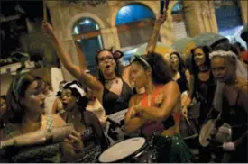  ?? SILVIA IZQUIERDO — THE ASSOCIATED PRESS ?? In this photo, Roma Neptune, center, takes part in the block party “Maria vem com as outras,” or “Maria, join the other women,” in Rio de Janeiro, Brazil.