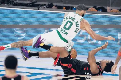  ?? MARK J. TERRILL/AP PHOTOS ?? The Celtics’Jayson Tatum fights for a loose ball wth the Raptors’ Kyle Lowry during the second half of Game 4 of the teams’ Eastern Conference semifinal playoff series Saturday in Lake Buena Vista, Fla.