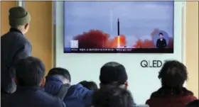  ?? AHN YOUNG-JOON — THE ASSOCIATED PRESS ?? People watch a TV screen showing file footage of North Korea’s missile launch at Seoul Railway Station in Seoul, South Korea, on Tuesday.