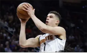  ?? RON SCHWANE — THE ASSOCIATED PRESS ?? Nuggets forward Michael Porter Jr. shoots against Cavaliers guard Darius Garland during the second half on Thursday in Cleveland.