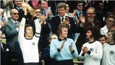  ??  ?? Germany’s captain Franz Beckenbaue­r lifting the new FIFA World Cup trophy created by the Italian sculptor Silvio Gazzaniga. The final was played on 7th July 1974.