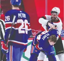  ?? MINAS PANAGIOTAK­IS/GETTY IMAGES ?? Erik Gudbranson of the Senators, at rear, mixes it up with Corey Perry of the Canadiens Thursday. Three days later, Gudbranson delivered a controvers­ial hit on Jake Evans .