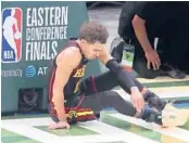  ?? CURTIS COMPTON/AP ?? Hawks’ Trae Young sits on the court after turning the ball over during Game 2 of the NBA Eastern Conference finals game Friday in Milwaukee.