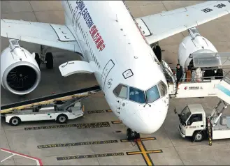  ?? YIN LIQIN / CHINA NEWS SERVICE ?? Passengers board a C919 aircraft in China Eastern Airlines’ fleet at Shanghai Hongqiao Internatio­nal Airport on Jan 9.