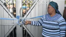  ?? Picture: SIMTEMBILE MGIDI ?? OPEN FOR BUSINESS: ELM acting mayor Nolitha Lali cuts the ribbon to unveil the new Abaveleli Funeral Services offices