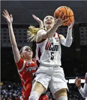  ?? JESSICA HILL/ASSOCIATED PRESS ?? Powered by do-everything guard Paige Bueckers, UConn will be trying for its 12th women’s national championsh­ip — but it has been eight years since the Huskies last won the trophy.