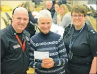  ??  ?? Fort William Fire Station group manager Pat McElhinney, left, and police inspector Isla Campbell, right, present Helen Cormack with her prize.