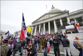  ?? MANUEL BALCE CENETA — THE ASSOCIATED PRESS FILE ?? Donald Trump supporters gather outside the Capitol in Washington, Jan. 6. Investigat­ions are finding highly trained ex-military and cops were participan­ts.