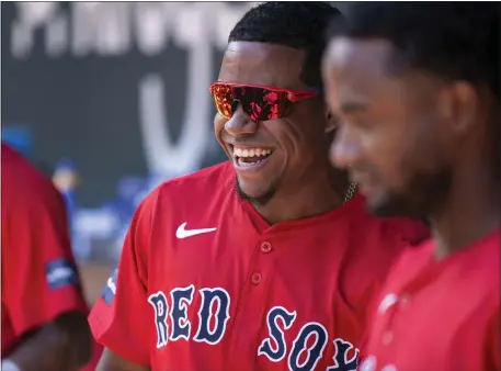  ?? JEFFREY MCWHORTER — THE ASSOCIATED PRESS ?? Boston Red Sox second baseman Enmanuel Valdez smiles in the dugout before a spring training game against the Texas Rangers on Tuesday in Arlington, Texas.