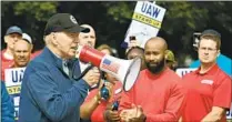  ?? Jim Watson AFP/Getty Images ?? AT A GENERAL MOTORS plant in Belleville, Mich., last week, Biden became the first sitting president to join a picket line.