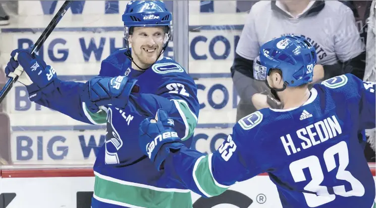  ?? DARRYL DYCK/THE CANADIAN PRESS ?? Daniel Sedin, left, celebrates a goal with twin brother Henrik in their final home game on Thursday, won 4-3 by the Canucks on Daniel’s overtime goal.