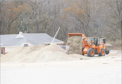  ?? Hearst Connecticu­t Media file photo ?? A loader dumps sand onto the beach at Greenwich Point as seen from Long Island Sound during a tour of the Greenwich coastline given by Greenwich Harbor Master Ian MacMillan of the damaged caused by Hurricane Sandy on Nov. 1, 2012.