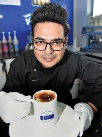  ?? Photo: Bev Lacey ?? NEW DRINK: Ali Kashif from Blue Ice Espresso on James Street will launch edible gold coffee today. The coffee is sprinkled with a 24-carat gold leaf.