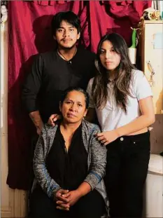  ?? Mary Inhea Kang / New York Times ?? Luz Gualman and her children, Francisco Guallpa, left, and Alexiss Rusvelia Guallpa, at their home in New York. In August, after having been arrested on charges of domestic violence, Segunda Guallpa, Gualman’s husband, took his life in Rikers Island. He was 58.