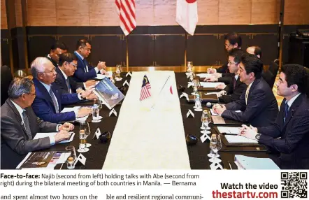  ??  ?? Face-to-face: Najib (second from left) holding talks with Abe (second from right) during the bilateral meeting of both countries in Manila. — Bernama
