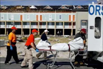  ?? DAVID GOLDMAN - THE ASSOCIATED PRESS ?? A body is removed after being discovered during the search of a housing structure in the aftermath of hurricane Michael in Mexico Beach, Fla., Friday.