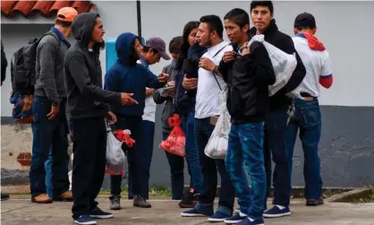  ??  ?? Migrants deported from the United States are seen outside the air force base upon their arrival in Guatemala City on 12 December 2019. Photograph: Orlando Estrada/AFP via Getty Images