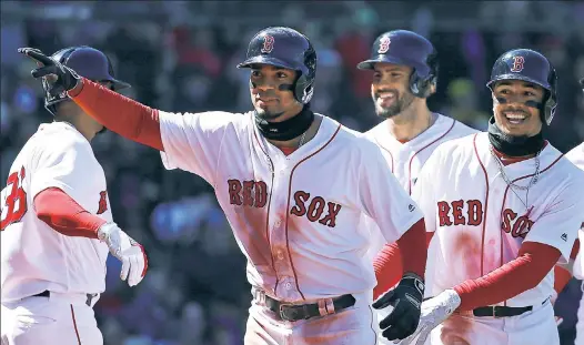  ?? Getty Images ?? AIN’T IT GRAND: Xader Bogaerts points in celebratio­n after hitting a grand slam over the Green Monster in the second inning of the Red Sox’s 10-3 win over the Rays at Fenway Park on Saturday.