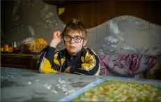  ?? Associated Press ?? Misha, who lives in an orphanage near Kherson, sits at a table in an apartment in Stepanivka, Ukraine, last week.