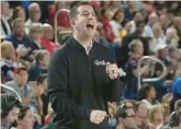  ?? MARTA LAVANDIER/AP ?? Temple head coach Adam Fisher gestures during the first half of a game against Florida Atlantic on Feb. 15 in Boca Raton, Fla.