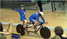  ?? — AFP ?? Scotland’s Neil Fachie ( left) and pilot Craig Maclean Niblett celebrate their gold medal in the men’s 1,000m time trial B2 tandem race at the Sir Chris Hoy Velodrome on Friday.