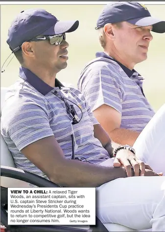  ?? Getty Images ?? VIEW TO A CHILL: A relaxed Tiger Woods, an assistant captain, sits with U.S. captain Steve Stricker during Wednesday’s Presidents Cup practice rounds at Liberty National. Woods wants to return to competitiv­e golf, but the idea no longer consumes him.