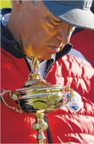  ?? THE ASSOCIATED PRESS ?? United States captain Davis Love III holds the Ryder Cup before a practice round for the Ryder Cup golf tournament Tuesday at Hazeltine National Golf Club in Chaska, Minn.