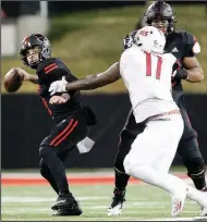  ?? (Arkansas Democrat-Gazette/Thomas Metthe) ?? Arkansas State quarterbac­k Layne Hatcher tries to get off a pass while being pressured by South Alabama’s Jamie Sheriff during the Red Wolves’ loss to the Jaguars on Saturday in Jonesboro.
More photos available at arkansason­line.com/1129asusa.