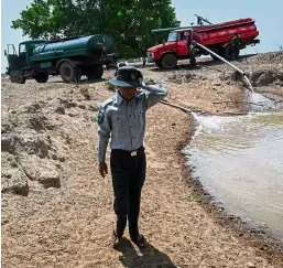  ?? — AFP ?? Tireless effort: A forest ranger pumping water to fill a lake at the Shwe Settaw nature reserve.