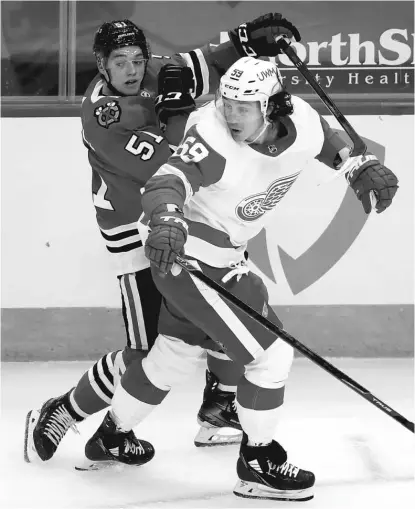  ?? GETTY IMAGES ?? Ian Mitchell (rear) played in 32 of the Hawks’ first 34 games last season but saw little action with them after that.