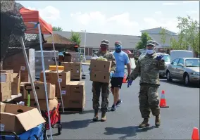  ?? LYRIC AQUINO — THE MORNING JOURNAL ?? Specialist Felicia Hernandez, 24, and specialist Nelson Laboy, 23, distribute food boxes to those in need.