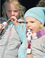  ?? Picture: EUGENE COETZEE ?? DELICIOUS MOUTHFUL: Mikayla Finlay, 6, left, and Madison Munro, 2, at St Dominic’s Priory Fair last Saturday