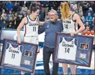  ?? JESSICA HILL/AP PHOTO ?? UConn’s Lou Lopez Senechal, left, and UConn’s Dorka Juhasz, right, smile as UConn head coach Geno Auriemma squeezes in for a photo during Senior Night ceremonies Feb. 27 in Storrs. UConn played the Mexican and French national anthems to honor Lopez Senechal and the Hungarian anthem in honor of Juhasz prior to the Star-Spangled Banner.