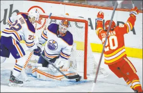  ?? Jeff Mcintosh The Associated Press ?? Flames right wing Blake Coleman exults after scoring against Oilers goalie Mikko Koskinen in Calgary’s win at Scotiabank Saddledome.