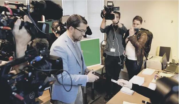  ?? PICTURE: STINA STJERNKVIS­T/AFP/GETTY IMAGES ?? 0 Jimmie Akesson, leader of the right-wing Sweden Democrats, casts his vote at a polling station in Stockholm yesterday