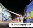  ??  ?? Fire crew damping down