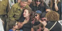  ?? | DAN BALILTY/AP ?? Relatives of Israeli Maj. Amotz Greenberg, 45, mourn Sunday during his funeral in the city of Hod Hasharon.