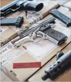  ?? CHRIS YOUNG THE CANADIAN PRESS ?? Toronto police display guns seized during a series of raids.