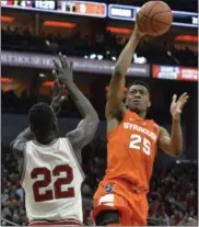  ??  ?? Syracuse’s Tyus Battle (25) shoots over the defense of Louisville’s Deng Adel (22) during the first half of an NCAA college basketball game, Sunday, Feb. 26, 2017, in Louisville, Ky.