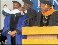  ?? CHRIS BARBER — DIGITAL FIRST MEDIA ?? Kenneth E. Scott receives the hood signifying his honorary doctorate of humane letters, as Lincoln President Richard Green, right, looks on.