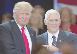  ?? AP PHOTO ?? BLUE-COLLAR BID: Republican presidenti­al candidate Donald Trump, left, with vice presidenti­al candidate Gov. Mike Pence yesterday in Roanoke, Va., has resonated with workers on jobs.