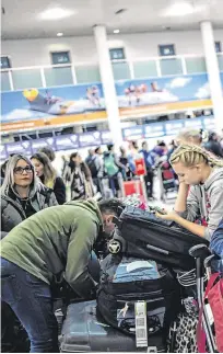  ??  ?? No fly zone: Passengers caught in the Gatwick chaos wait for more informatio­n