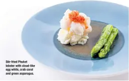  ??  ?? Stir-fried Phuket lobster with cloud- like egg white, crab coral and green asparagus.