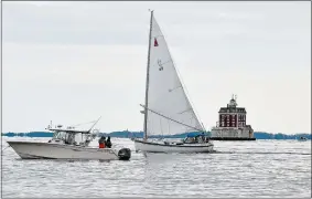  ?? SARAH GORDON/THE DAY ?? A fishing boat and a sailboat move past New London Ledge Light, as seen from Ocean Beach in New London, on Sunday.